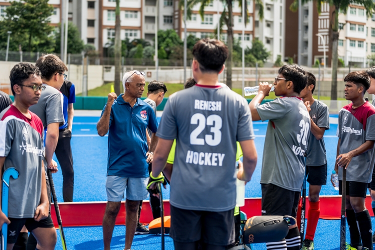 hockey coach prepping team during warm ups