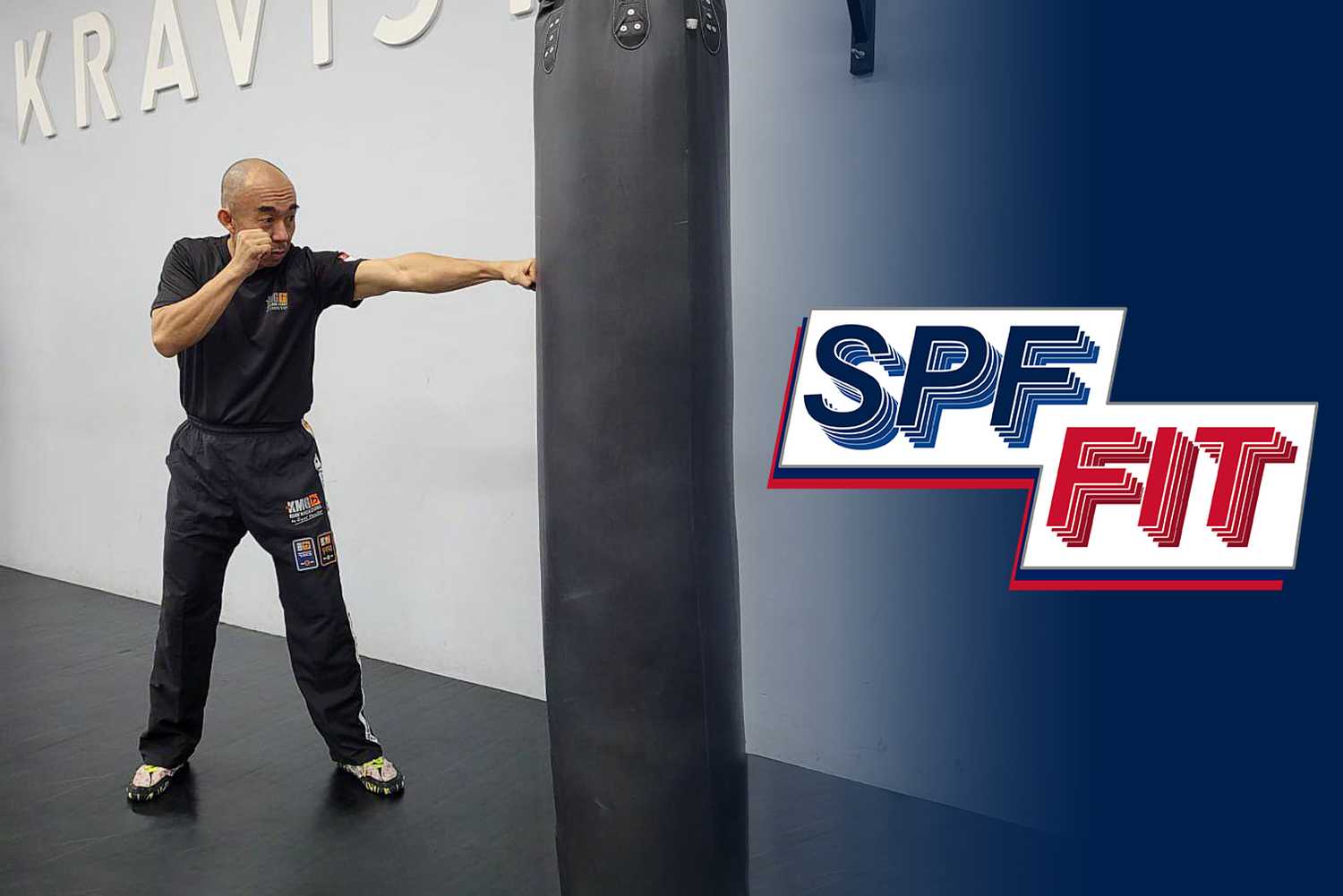 Inspector Tan Buck Song punching a black punching bag in his gym, a navy blue gradient fades out from the left of the picture, the words "SPF Fit" on it. 