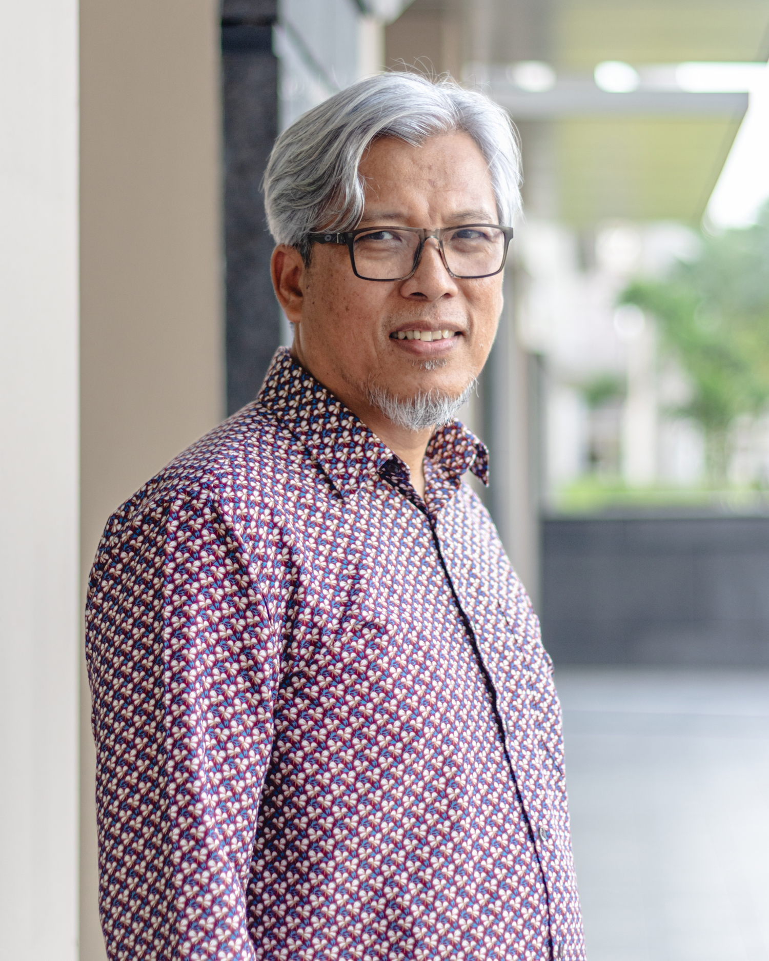 Superintendent of Police Amri Bin Amin, who has now been retired, looks at the camera in a profile shot.