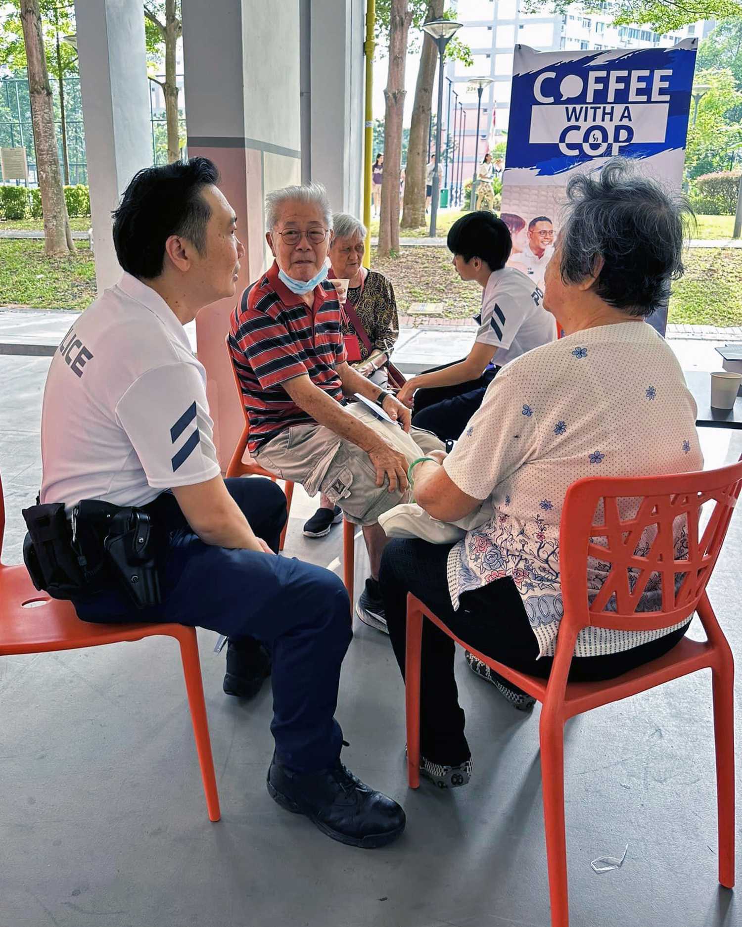 An officer from Clementi NPC chatting with a member of the public.