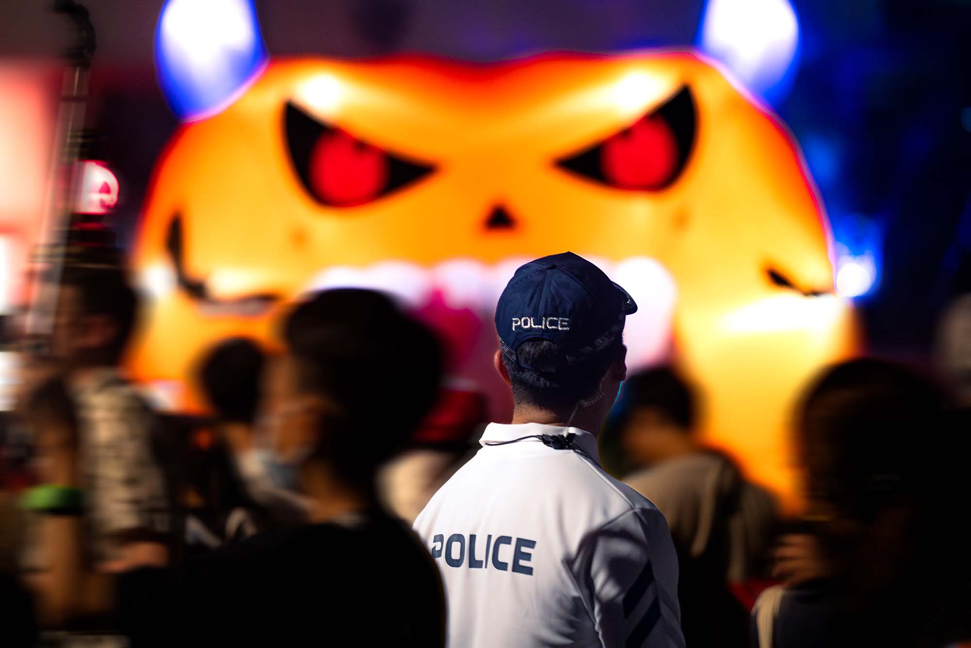 cpu officer looking towards a big inflatable pumpkin balloon