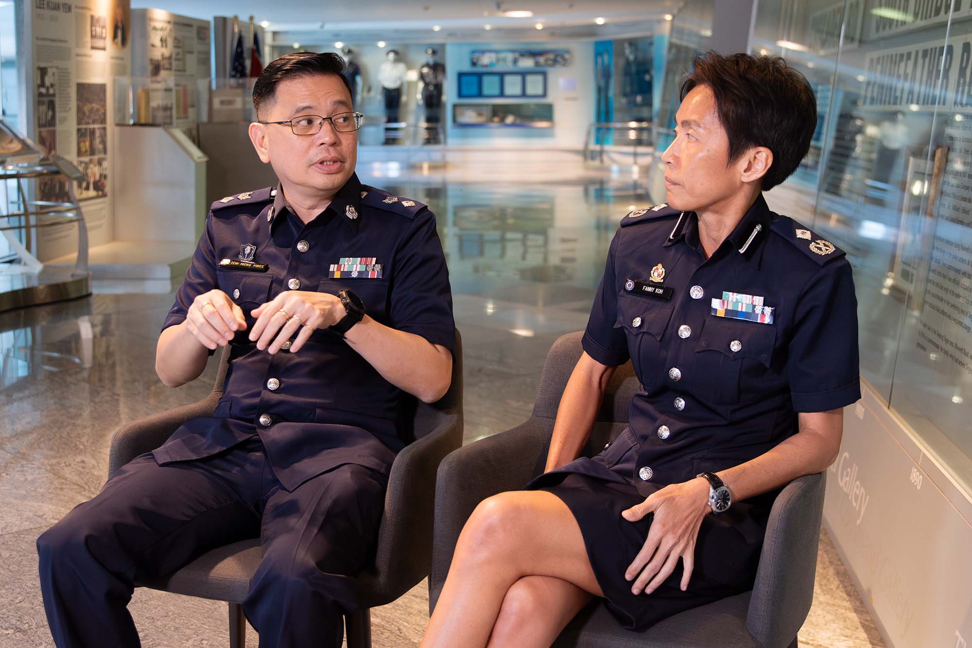 dsp tew on the left and ac fanny koh on the right seated on two chair with a walkway behind them to the police heritage centre