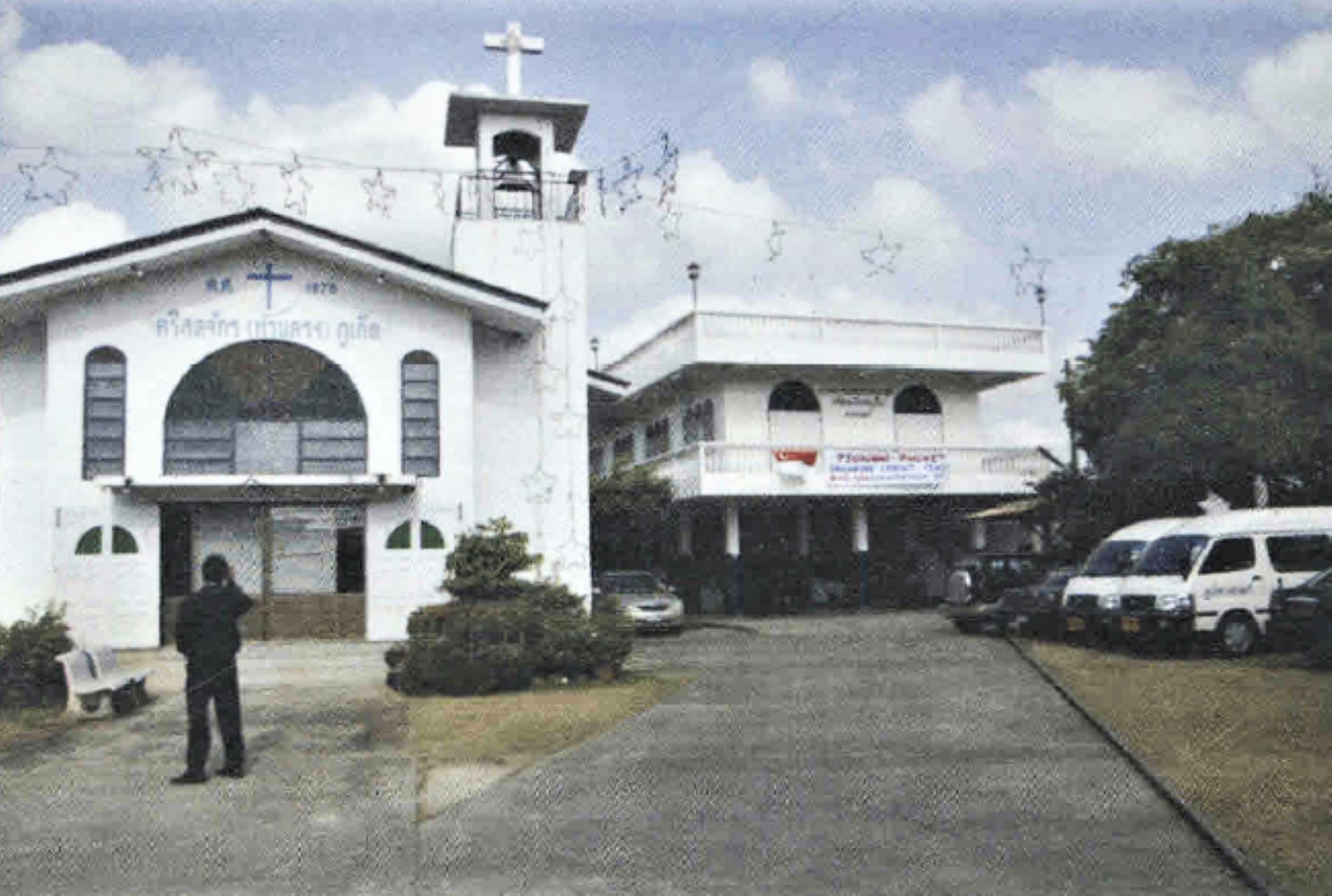 a photo of an old church that is uphill 