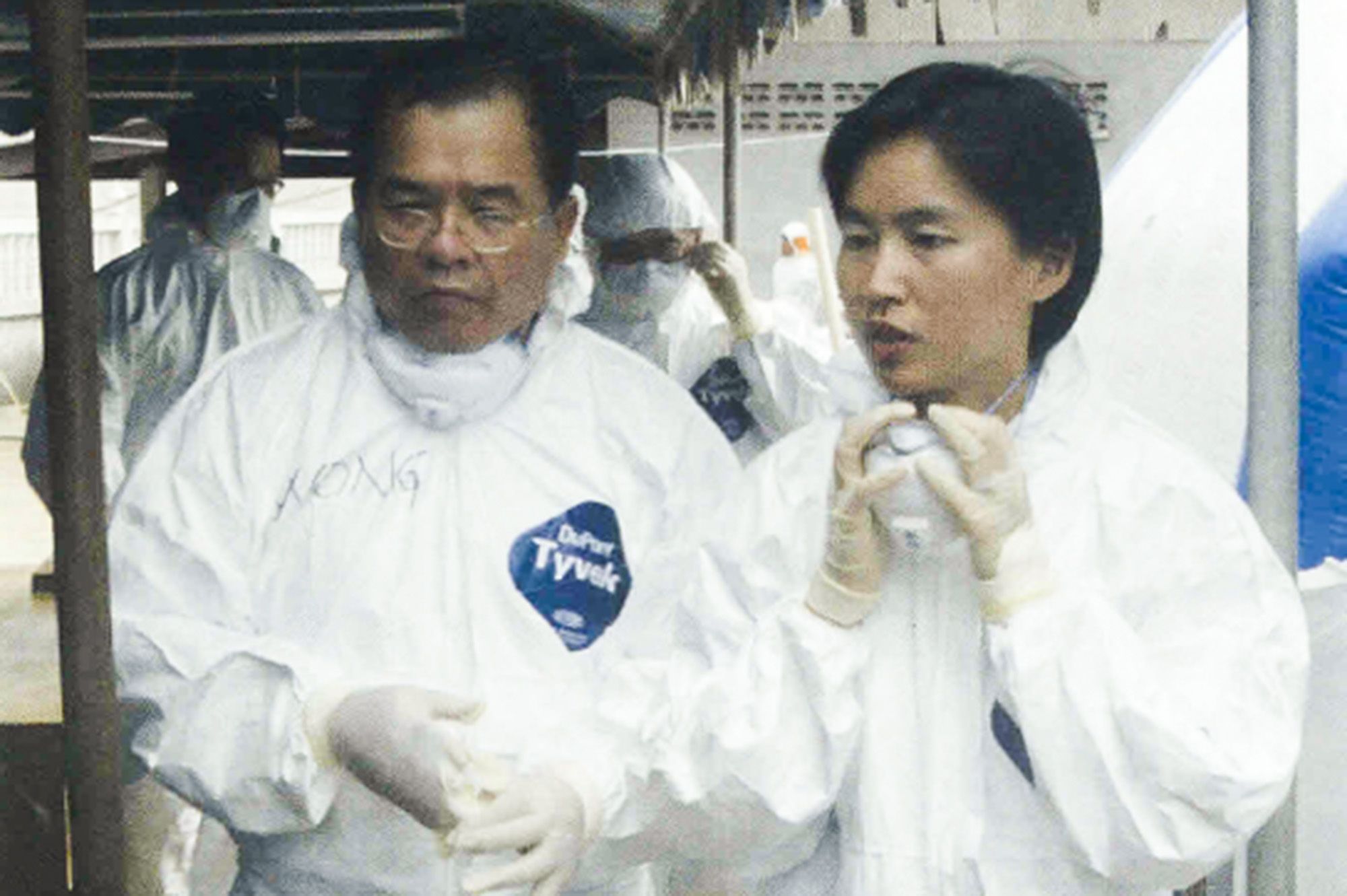 the officers in white coveralls and gloves. The masks are resting on their chin