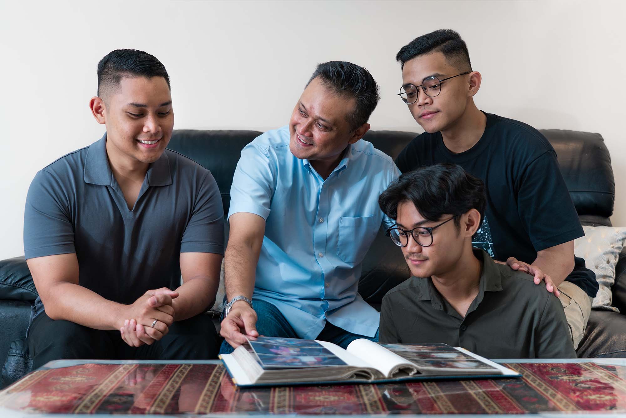 Insp Fazli (middle) with his three sons: Sgt Fikri (left), Sgt Rushaidi (right) and 19-year-old Muhammad Thafiq Bin Muhammad Fazli, currently a student but with similar aspirations of joining the SPF like his brothers.